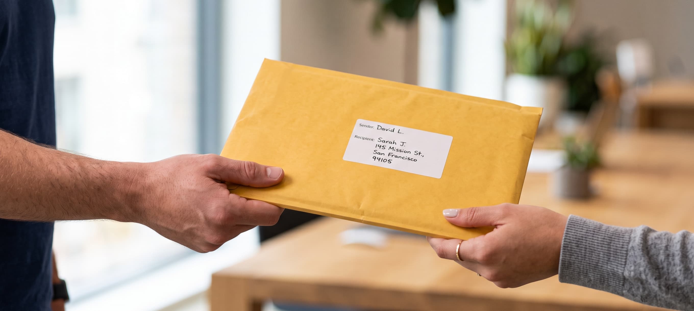 A courier handing a document envelope to a customer